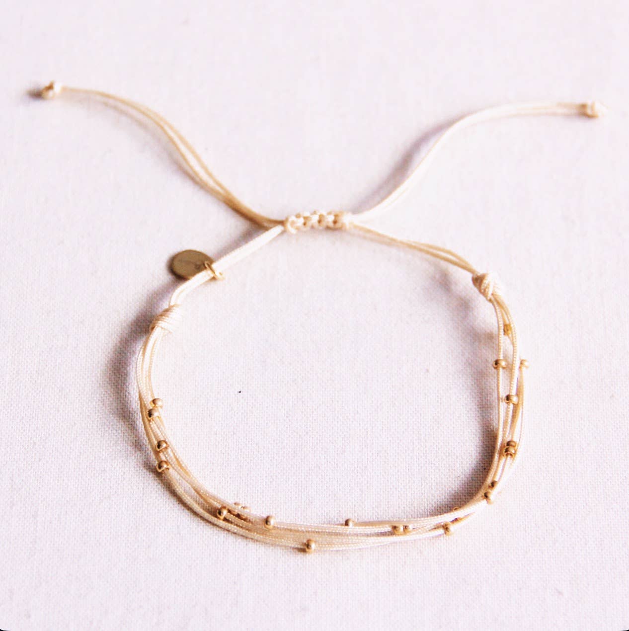 Viervoudige satijnen armband met kralen - zand